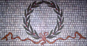Stone wreath mosaic in entryway